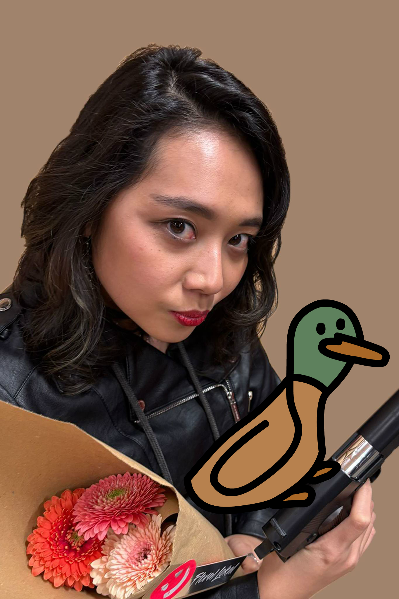 Improviser Neila in costume with a cartoon duck sitting on her prop gun