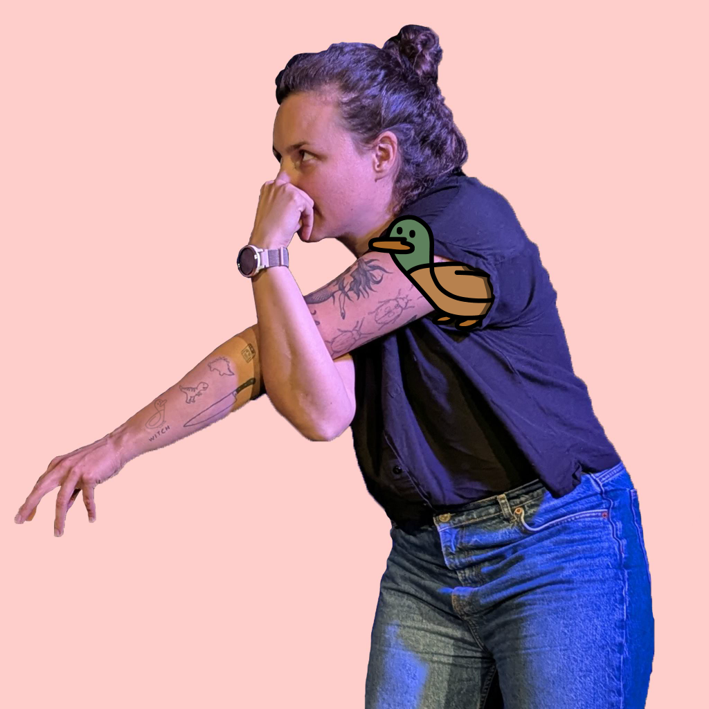 Laura pretending to be an elephant with a duck sticking out of her sleeve.
