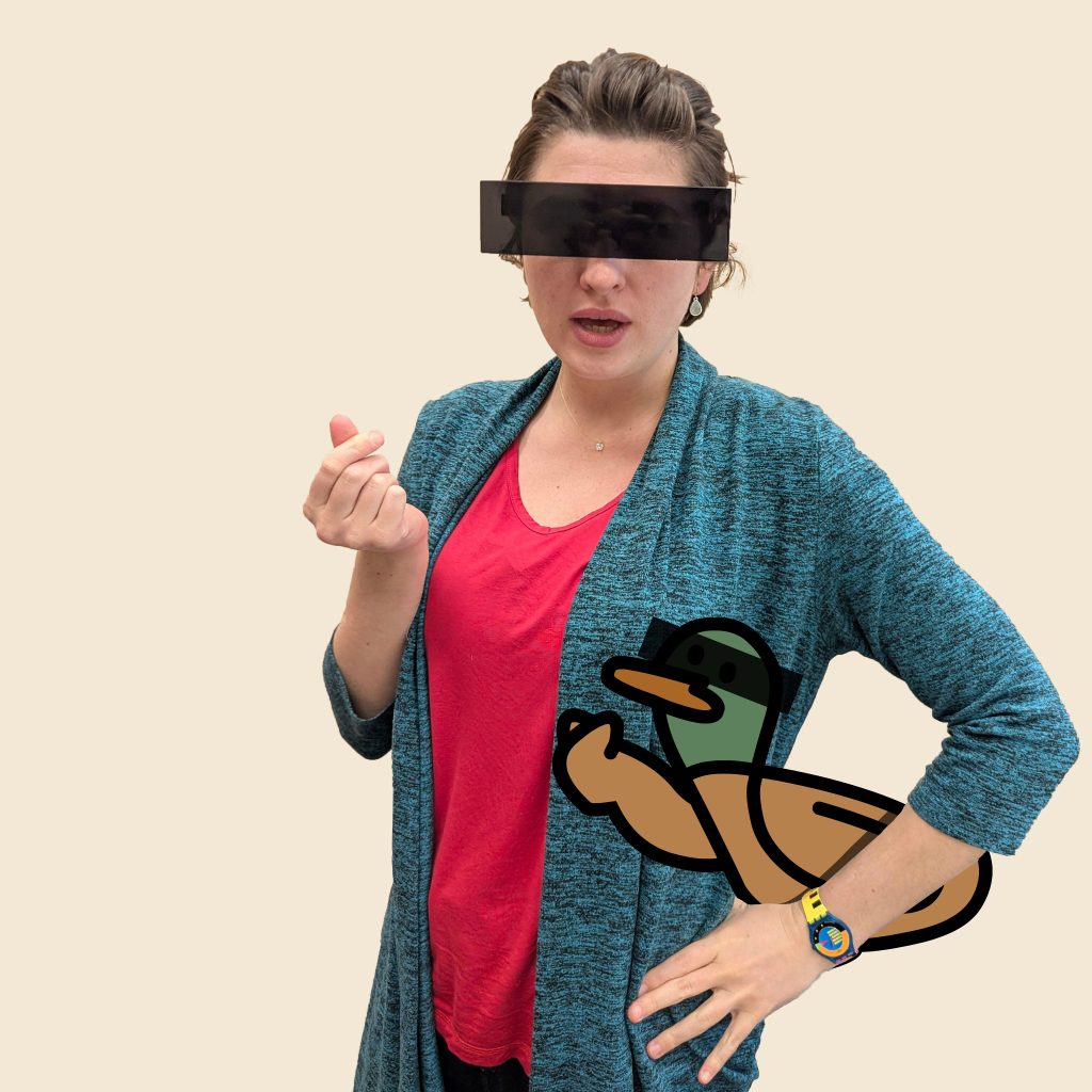 Mimi wearing censoring glasses and making the heart sign with her fingers. Under her arm there is a duck wearing the same glasses and making the same sign.
