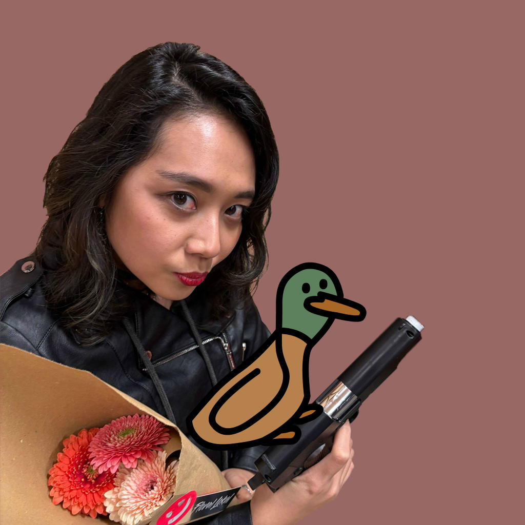 Neila in a leather jacket holding flowers and a gun with a duck standing on it.